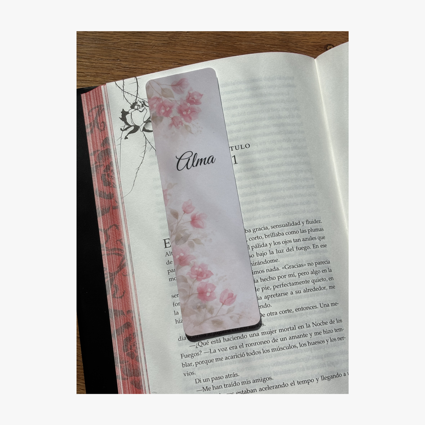 Marcapáginas personalizado con nombre diseño buganvilla colocado dentro de un libro de Rasdelma.